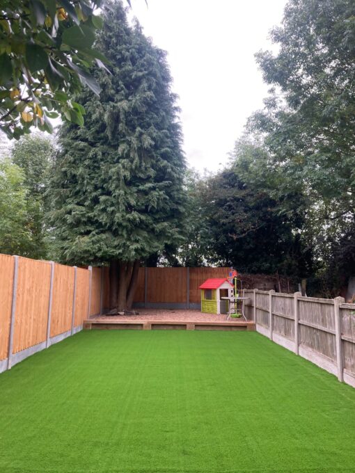 This is a photo of a back garden with fake grass. Leicester artificial grass services installed this